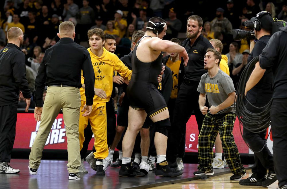 IowaÕs Tony Cassioppi celebrates with teammate Spencer Lee after defeating WisconsinÕs Trent Hillger at heavyweight Sunday, December 1, 2019 at Carver-Hawkeye Arena. Cassioppi won the match 3-2. (Brian Ray/hawkeyesports.com)