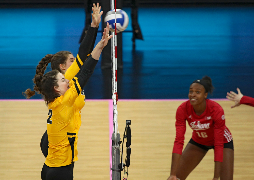 Iowa’s Blythe Rients (11) and Courtney Buzzerio (2) get their hands on a shot during their match at Carver-Hawkeye Arena in Iowa City on Sunday, Oct 20, 2019. (Stephen Mally/hawkeyesports.com)