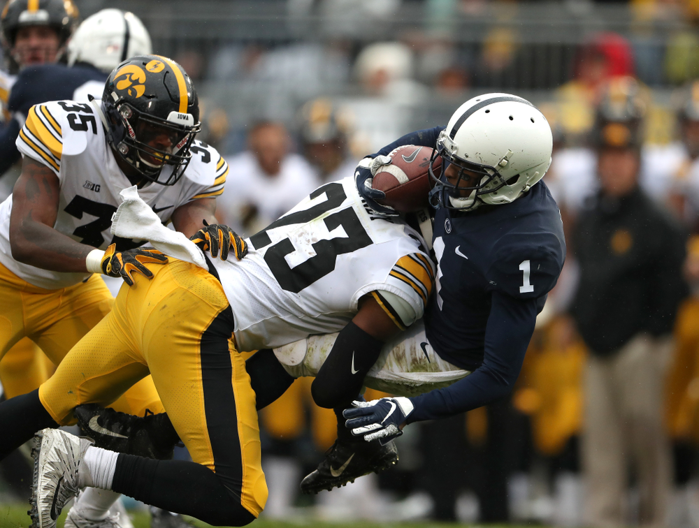 Iowa Hawkeyes wide receiver Dominique Dafney (23) hits Penn State Nittany Lions wide receiver KJ Hamler (1) on a kick off Saturday, October 27, 2018 at Beaver Stadium in University Park, Pa. (Brian Ray/hawkeyesports.com)