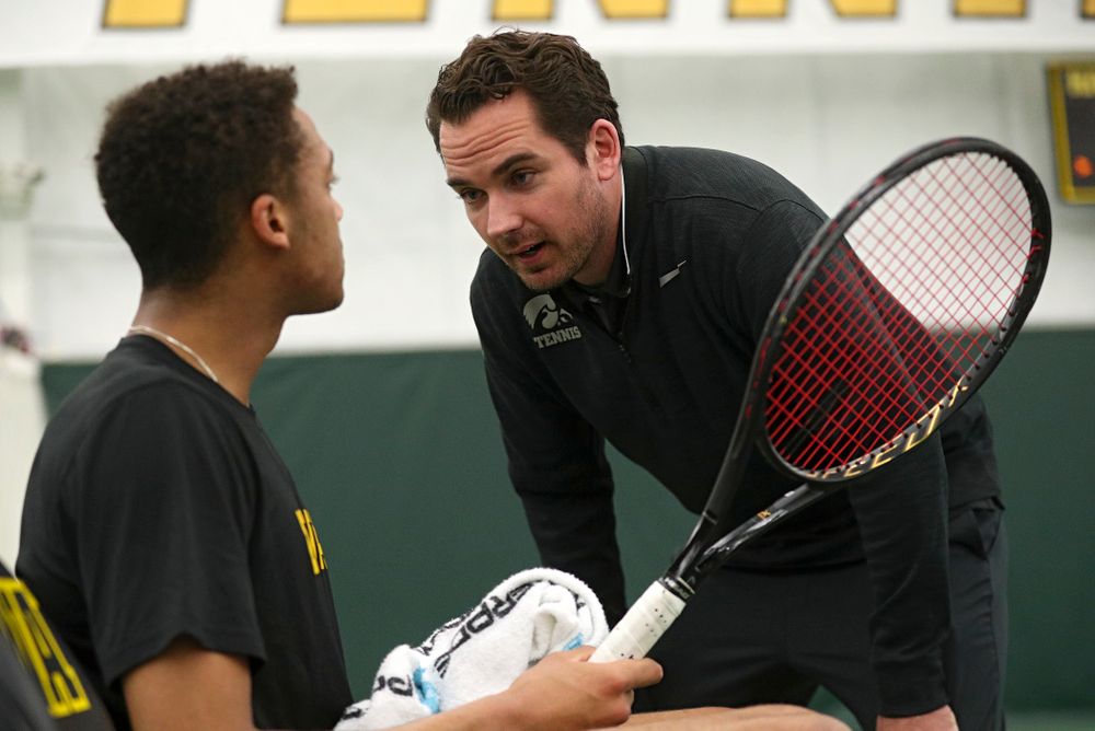 Mellecker Family Head Men's Tennis Coach Ross Wilson (right) talks with Oliver Okonkwo during his singles match at the Hawkeye Tennis and Recreation Complex in Iowa City on Friday, March 6, 2020. (Stephen Mally/hawkeyesports.com)