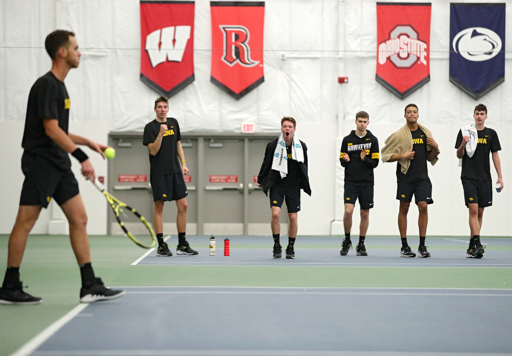 Iowa’s Nikita Snezhko, Jason Kerst, Morgan Lohan, Oliver Okonkwo, and Matt Clegg celebrate after Kareem Allaf (left) won his match against Marquette at the Hawkeye Tennis and Recreation Complex in Iowa City on Saturday, January 25, 2020. (Stephen Mally/hawkeyesports.com)