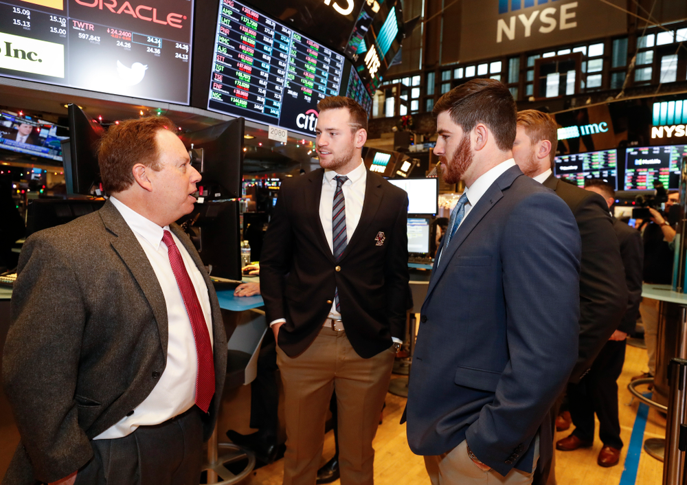 Iowa Hawkeyes linebacker Josey Jewell (43), defensive back Joshua Jackson (15), offensive lineman Sean Welsh (79) and head coach Kirk Ferentz ring the opening bell at the New York Stock Exchange Tuesday, December 26, 2017 in New York. (Brian Ray/hawkeyesports.com)
