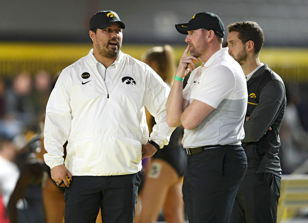 Iowa assistant coach/recruiting coordinator Jason Wakenight (from left) talks with director of track and field Joey Woody between the men’s and women’s 1600 meter relay event during the Hawkeye Invitational at the Recreation Building in Iowa City on Saturday, January 11, 2020. (Stephen Mally/hawkeyesports.com)
