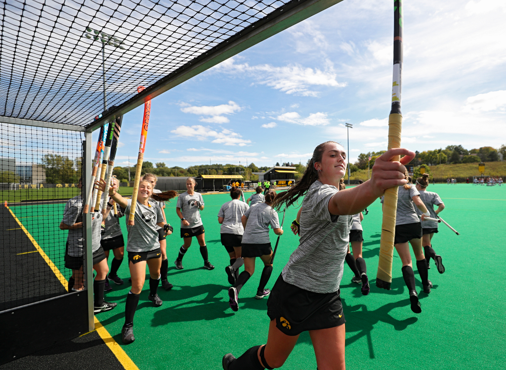 Iowa’s Anthe Nijziel (6) grabs her stick with her teammates before the start of their match at Grant Field in Iowa City on Friday, Oct 4, 2019. (Stephen Mally/hawkeyesports.com)