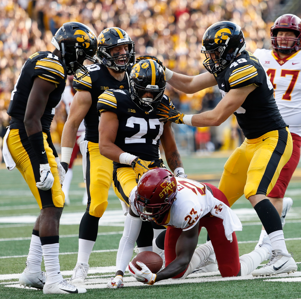 Iowa Hawkeyes defensive back Michael Ojemudia (11), Iowa Hawkeyes defensive back Amani Hooker (27), Iowa Hawkeyes defensive back Jake Gervase (30), Iowa Hawkeyes linebacker Nick Niemann (49)