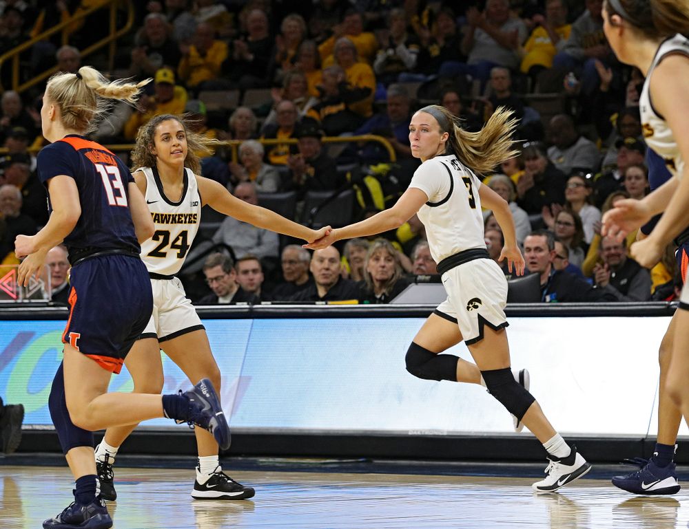 Iowa Hawkeyes guard Gabbie Marshall (24) gives guard Makenzie Meyer (3) a high-five after Meyer made a 3-pointer during the third quarter of their game at Carver-Hawkeye Arena in Iowa City on Tuesday, December 31, 2019. (Stephen Mally/hawkeyesports.com)