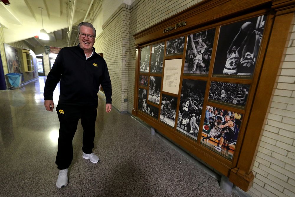 Iowa Hawkeyes head coach Fran McCaffery stands by a display with his photo in it before practice at the Palestra Friday, January 3, 2020 in Philadelphia. (Brian Ray/hawkeyesports.com)