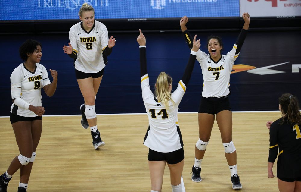Iowa Hawkeyes middle blocker Amiya Jones (9), Iowa Hawkeyes right side hitter Reghan Coyle (8) and Iowa Hawkeyes setter Brie Orr (7) celebrate after winning a point during a match against Penn State at Carver-Hawkeye Arena on November 3, 2018. (Tork Mason/hawkeyesports.com)