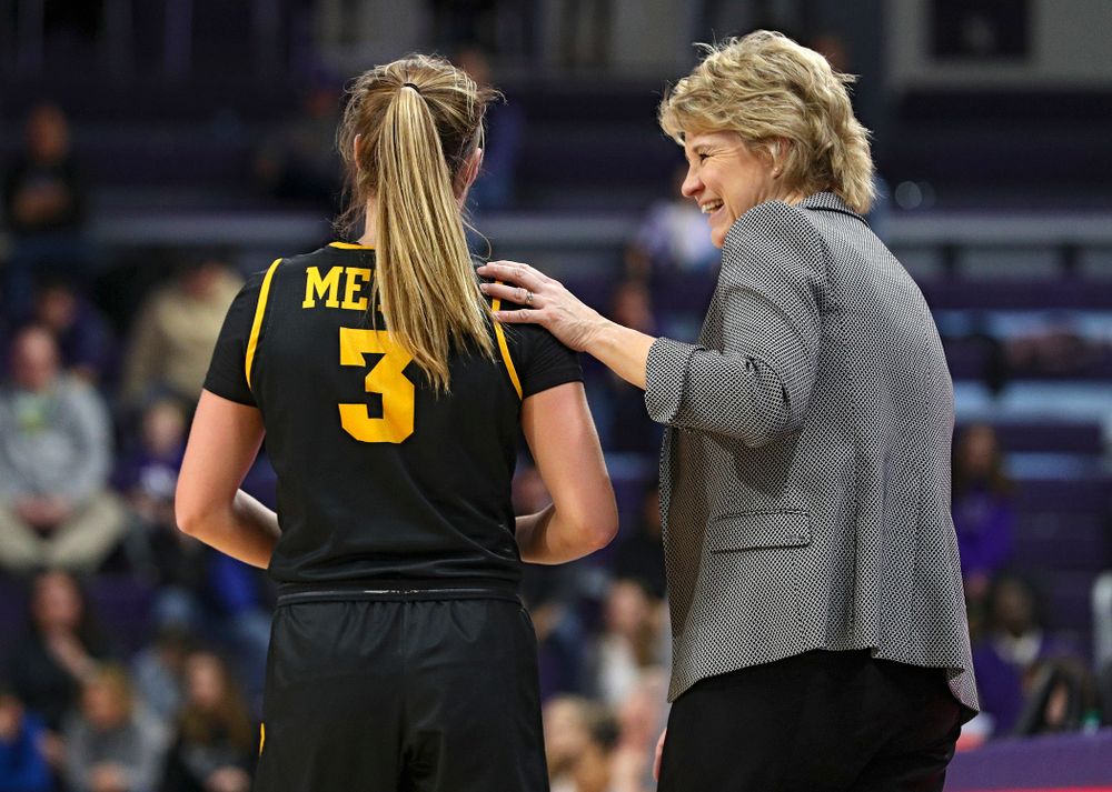 Iowa Hawkeyes guard Makenzie Meyer (3) shares a laugh with head coach Lisa Bluder during the third quarter of their game at Welsh-Ryan Arena in Evanston, Ill. on Sunday, January 5, 2020. (Stephen Mally/hawkeyesports.com)