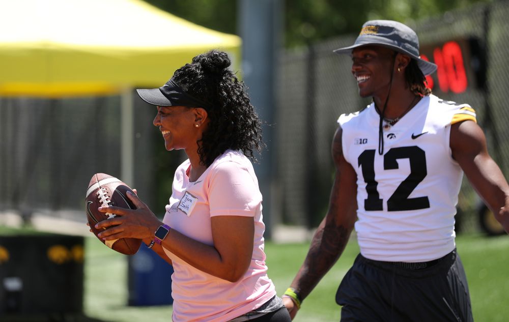 Tyjauna Smith makes a catch in front of her son, Iowa Hawkeyes wide receiver Brandon Smith (12), during the 2019 Iowa Ladies Football Academy Saturday, June 8, 2019 at the Hansen Football Performance Center. (Brian Ray/hawkeyesports.com)