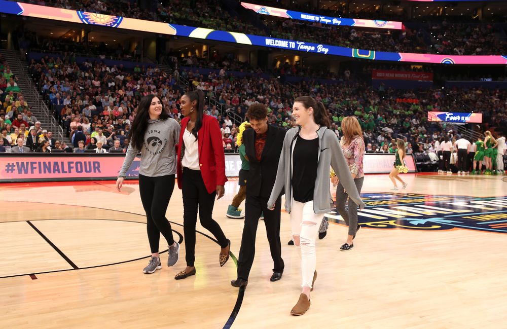 Iowa Hawkeyes forward Megan Gustafson (10) and Iowa State's Bridget Carleton are introduced with Naismith Starting 5 namesakes during a timeout in the second half of the National Semi-Final between Baylor and Oregon Friday, April 5, 2019 at Amalie Arena in Tampa, FL. (Brian Ray/hawkeyesports.com)