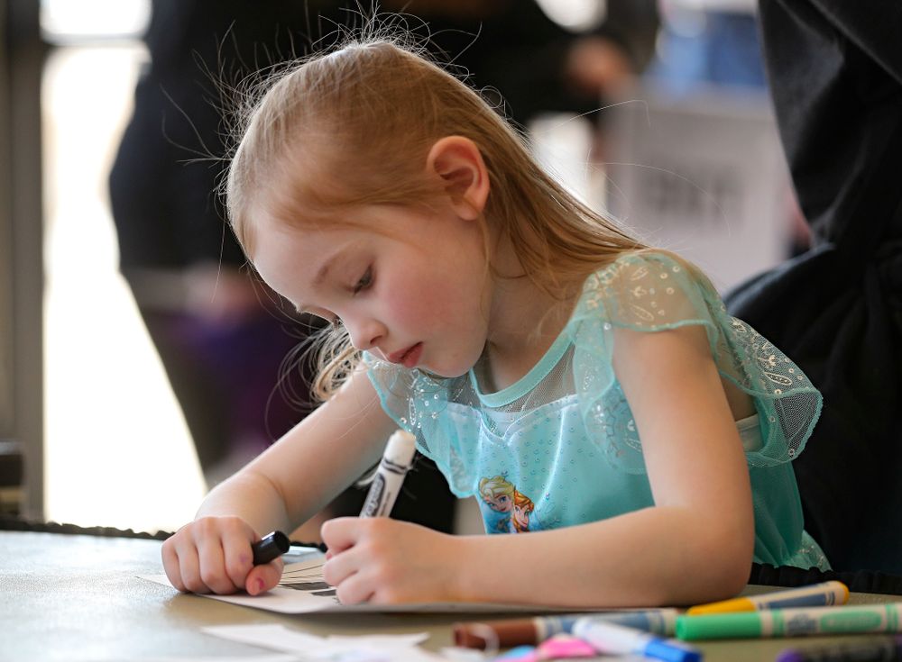 A young fan works on coloring a mask on Superhero and Princess Day before the meet at Carver-Hawkeye Arena in Iowa City on Sunday, March 8, 2020. (Stephen Mally/hawkeyesports.com)