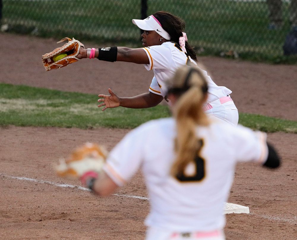 Iowa first baseman DoniRae Mayhew (24) pulls in a throw as they turn a double play as pitcher Allison Doocy (3) looks on during the fifth inning of their game against Iowa State at Pearl Field in Iowa City on Tuesday, Apr. 9, 2019. (Stephen Mally/hawkeyesports.com)