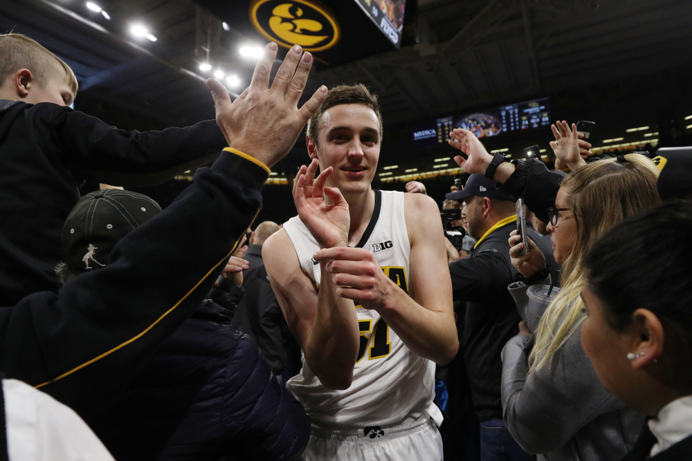 Iowa Hawkeyes forward Nicholas Baer (51) celebrates with fans after defeating the Michigan Wolverines Friday, February 1, 2019 at Carver-Hawkeye Arena. (Brian Ray/hawkeyesports.com)
