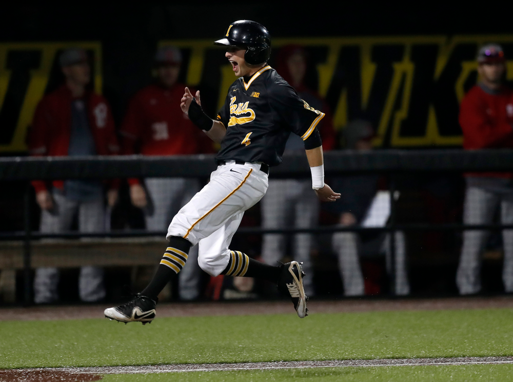 Iowa Hawkeyes infielder Mitchell Boe (4) celebrates as he scores on a walk off grand slam by catcher Tyler Cropley (5) against the Bradley Braves Wednesday, March 28, 2018 at Duane Banks Field. (Brian Ray/hawkeyesports.com)
