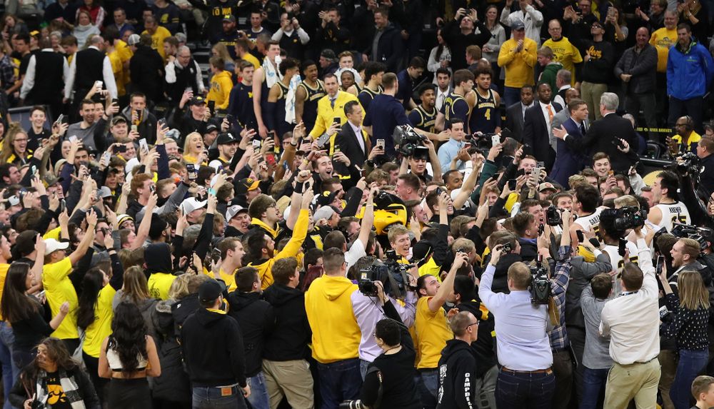 Fans storm the court after Iowa Hawkeyes defeated the Michigan Wolverines Friday, February 1, 2019 at Carver-Hawkeye Arena. (Brian Ray/hawkeyesports.com)