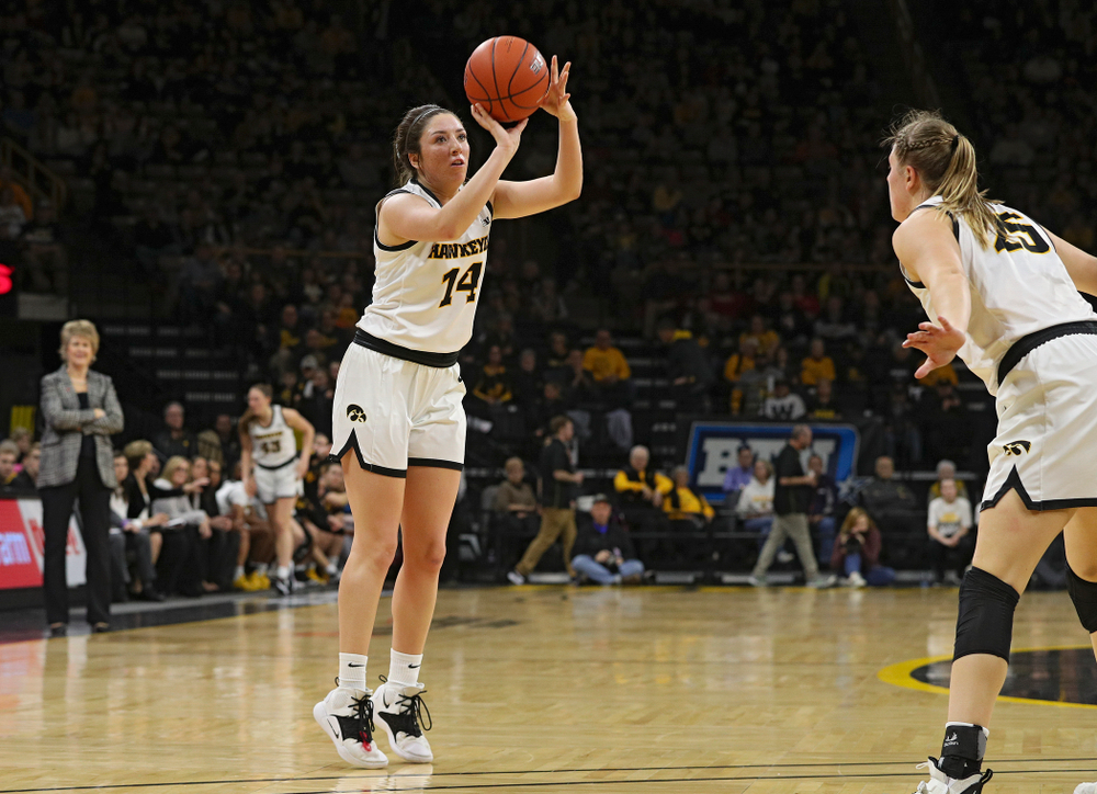 Iowa Hawkeyes guard Mckenna Warnock (14) makes a 3-pointer during the second quarter of their game at Carver-Hawkeye Arena in Iowa City on Sunday, January 26, 2020. (Stephen Mally/hawkeyesports.com)
