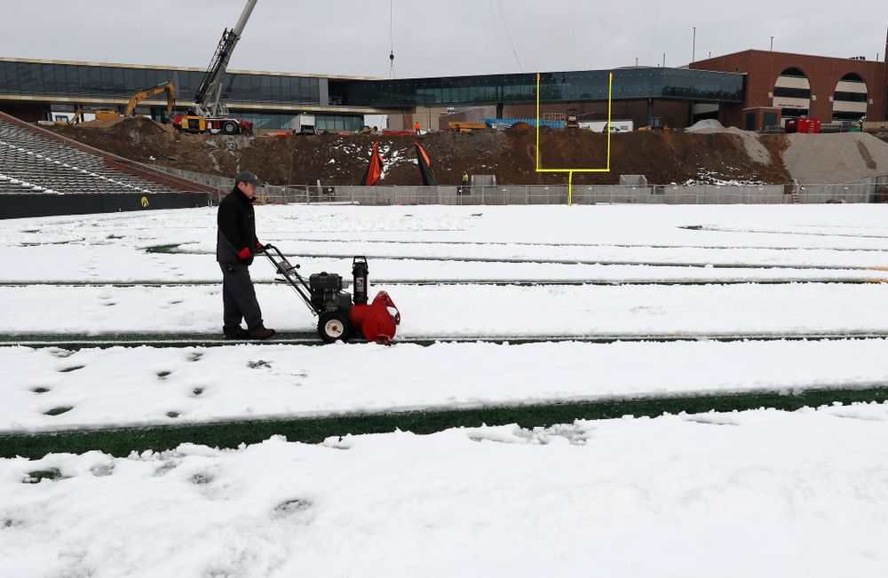 Members of the Iowa Athletics Turf Management staff create the #SnowWave for kids in the Stead Family Children's Hospital Thursday, February