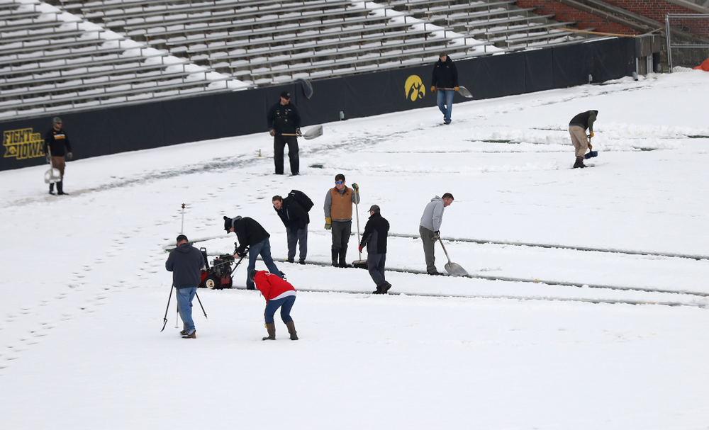 Members of the Iowa Athletics Turf Management staff create the #SnowWave for kids in the Stead Family Children's Hospital Thursday, February
