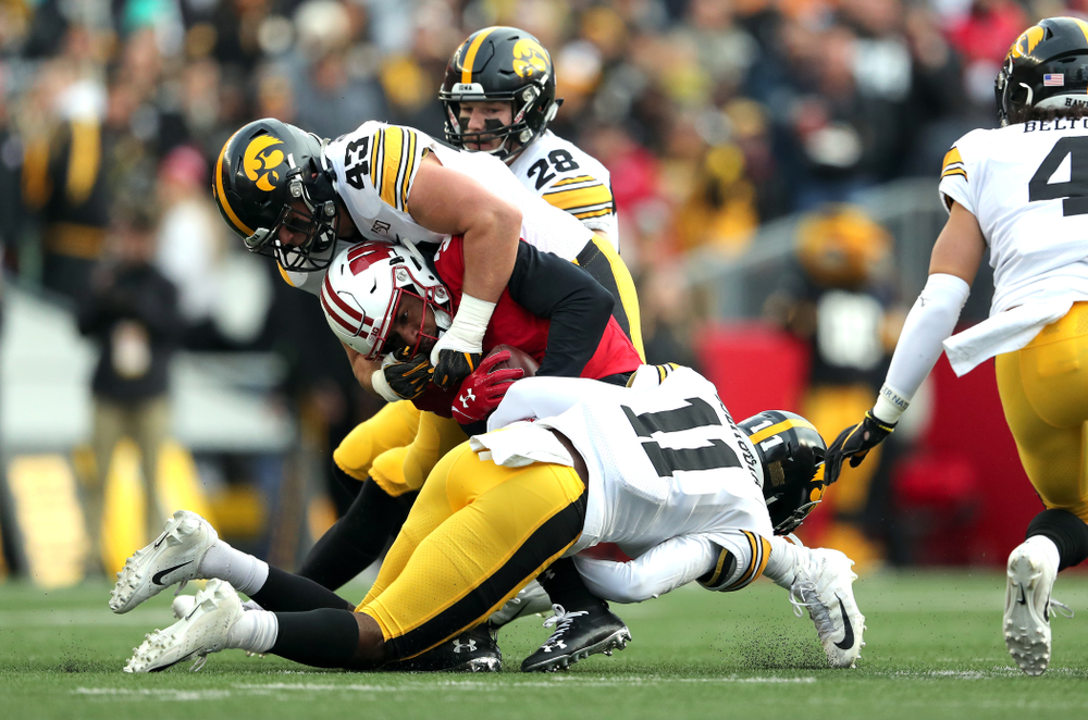 Iowa Hawkeyes linebacker Dillon Doyle (43) and defensive back Michael Ojemudia (11) against the Wisconsin Badgers Saturday, November 9, 2019 at Camp Randall Stadium in Madison, Wisc. (Brian Ray/hawkeyesports.com)