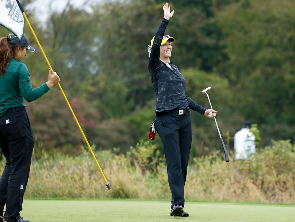 Iowa's Shawn Rennegarbe waves to teammate Kristin Glesne after sinking a birdie putt during the final round of the Diane Thomason Invitational at Finkbine Golf Course on September 30, 2018. (Tork Mason/hawkeyesports.com)