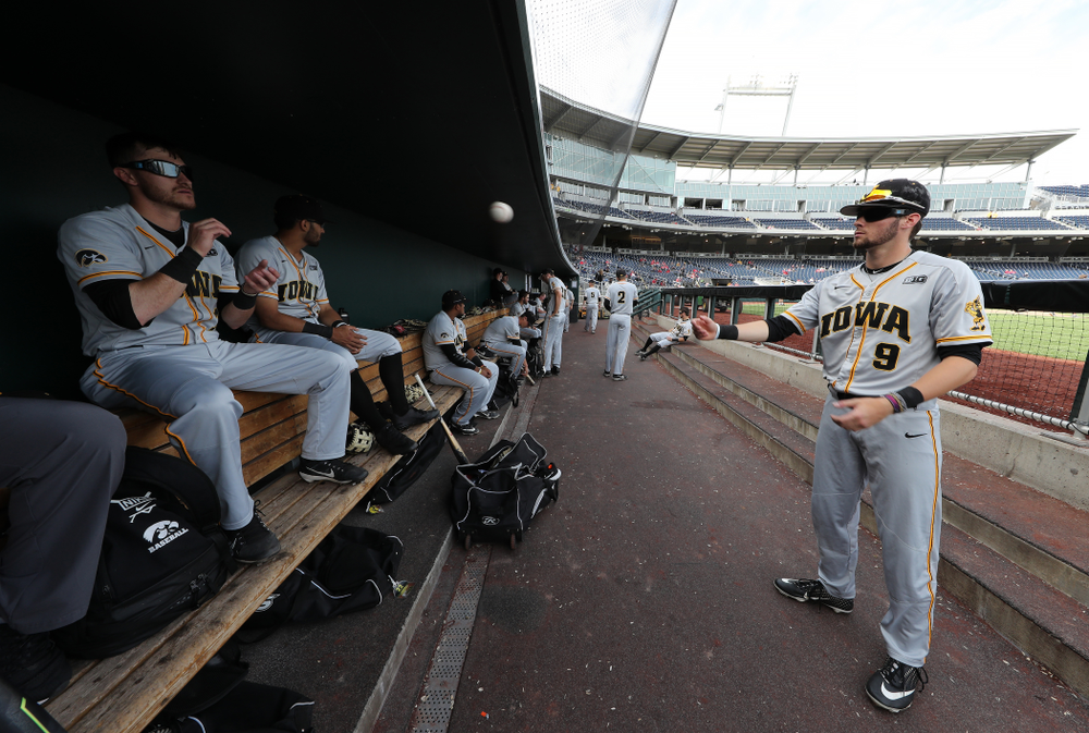 Iowa Hawkeyes outfielder Ben Norman (9) and Tanner Wetrich (16) wear special goggles that flicker to improve hand eye coordination as they play catch before their game against the Indiana Hoosiers in the first round of the Big Ten Baseball Tournament Wednesday, May 22, 2019 at TD Ameritrade Park in Omaha, Neb. (Brian Ray/hawkeyesports.com)