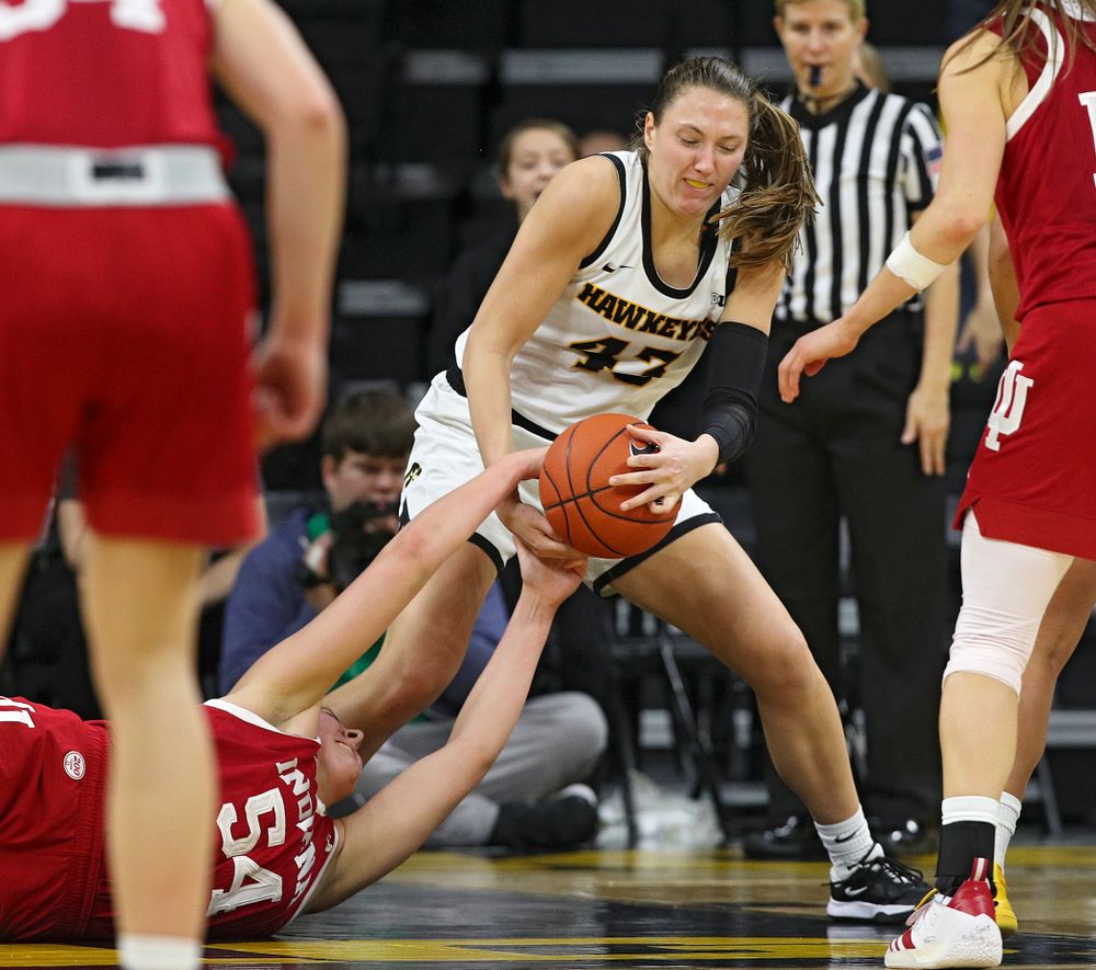 Iowa Hawkeyes forward Amanda Ollinger (43) and Indiana Hoosiers forward Mackenzie Holmes (54) hang on to a held ball during the fourth quarter of their game at Carver-Hawkeye Arena in Iowa City on Sunday, January 12, 2020. (Stephen Mally/hawkeyesports.com)