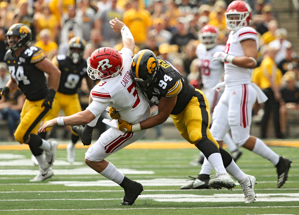 Iowa Hawkeyes defensive end A.J. Epenesa (94) hits Rutgers quarterback McLane Carter during the second quarter of their Big Ten Conference football game at Kinnick Stadium in Iowa City on Saturday, Sep 7, 2019. (Stephen Mally/hawkeyesports.com)