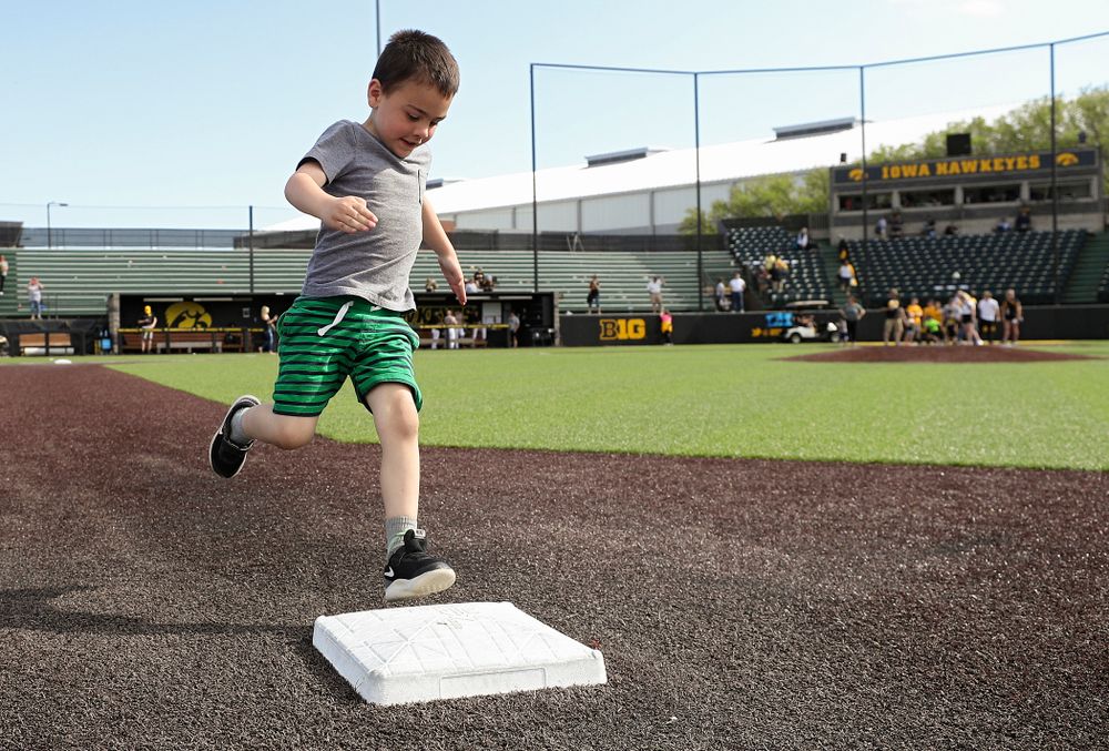 Kids run the bases after Iowa's game against UC Irvine at Duane Banks Field in Iowa City on Sunday, May. 5, 2019. (Stephen Mally/hawkeyesports.com)