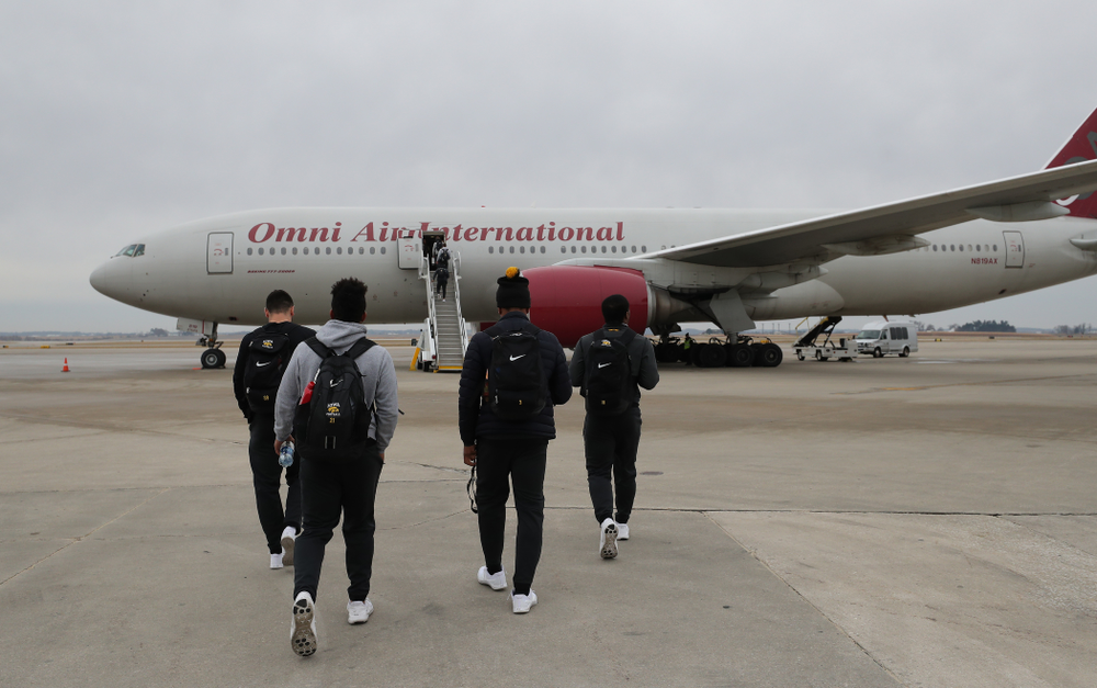 The Iowa Hawkeyes board the team plane Wednesday, December 26, 2018 as they travel to Tampa, Florida for the Outback Bowl. (Brian Ray/hawkeyesports.com)
