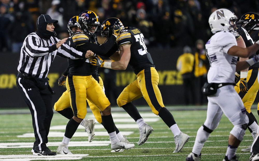 Iowa Hawkeyes defensive back Amani Hooker (27) and Iowa Hawkeyes defensive back Jake Gervase (30) celebrate after Gervase's interception during a game against Northwestern at Kinnick Stadium on November 10, 2018. (Tork Mason/hawkeyesports.com)