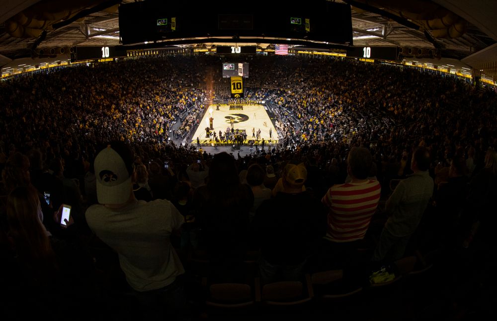 Megan Gustafson stands with her family as her number is raised into the rafters during a jersey retirement ceremony Sunday, January 26, 2020 at Carver-Hawkeye Arena. (Brian Ray/hawkeyesports.com)