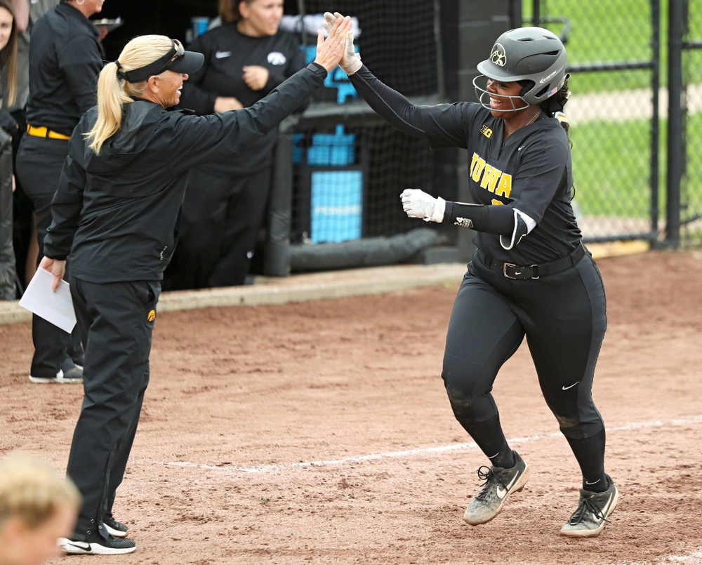 Iowa’s DoniRae Mayhew (24) gets a high-five from head coach Renee Gillispie as she rounds the bases after hitting a 3-run home run during the sixth inning of their game against Iowa Softball vs Indian Hills Community College at Pearl Field in Iowa City on Sunday, Oct 6, 2019. (Stephen Mally/hawkeyesports.com)
