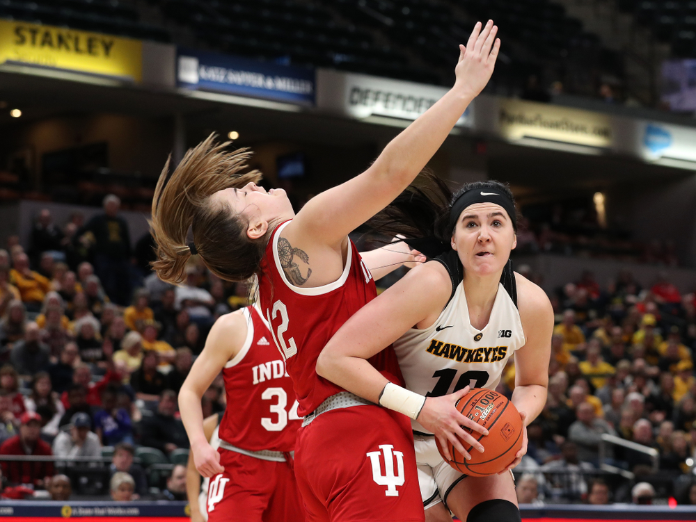 Iowa Hawkeyes forward Megan Gustafson (10) draws a foul on her way to making a basket against the Indiana Hoosiers in the quarterfinals of the Big Ten Tournament Friday, March 8, 2019 at Bankers Life Fieldhouse in Indianapolis, Ind. (Brian Ray/hawkeyesports.com)