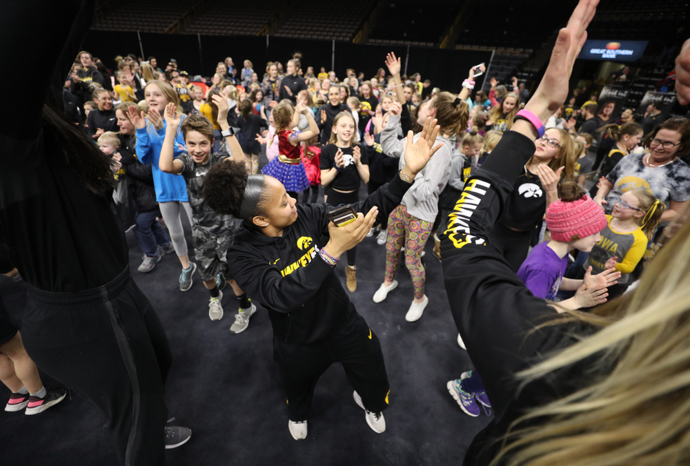 Iowa Women's Basketball seniors Megan Gustafson, Tania Davis, and forward Hannah Stewart (21) present the awards and dance the Cha Cha Slide following the Gymhawks meet against Illinois Saturday, February 16, 2019 at Carver-Hawkeye Arena. (Brian Ray/hawkeyesports.com)