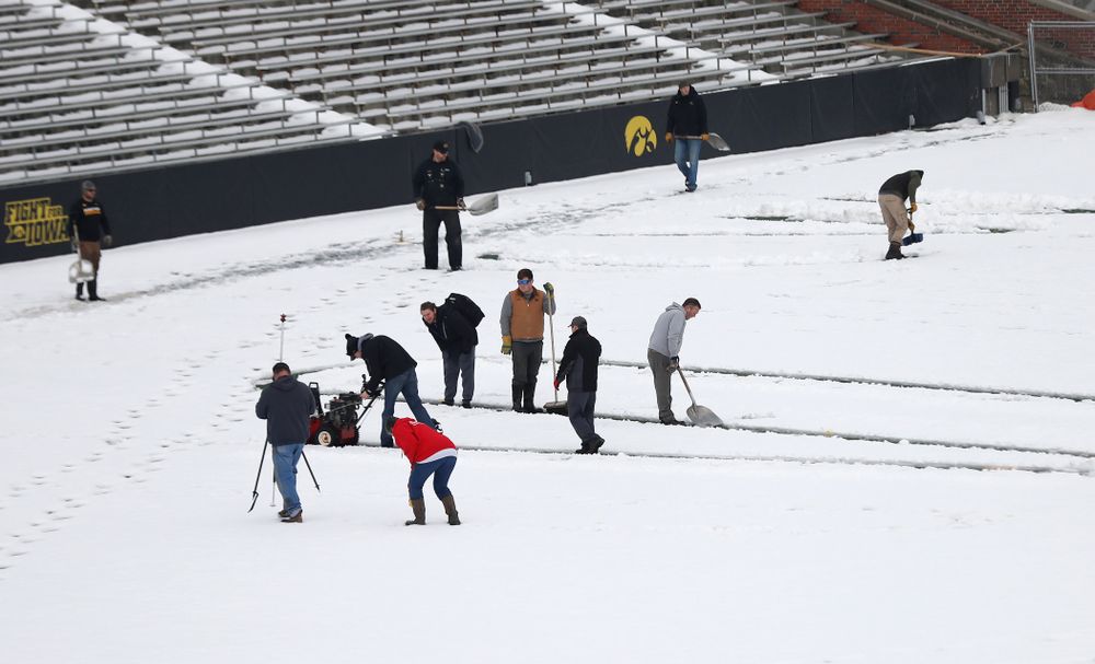 Members of the Iowa Athletics Turf Management staff create the #SnowWave for kids in the Stead Family Children's Hospital Thursday, February