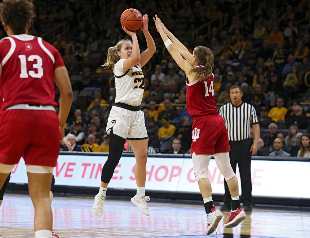 Iowa Hawkeyes guard Kathleen Doyle (22) makes a basket over the hands of Indiana Hoosiers guard Ali Patberg (14) during the third quarter of their game at Carver-Hawkeye Arena in Iowa City on Sunday, January 12, 2020. (Stephen Mally/hawkeyesports.com)