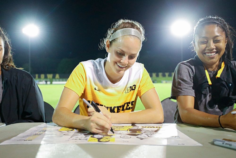 Iowa goalkeeper Claire Graves (1) signs a poster during an autograph session after their match against Western Michigan at the Iowa Soccer Complex in Iowa City on Thursday, Aug 22, 2019. (Stephen Mally/hawkeyesports.com)