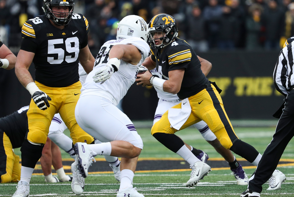 Iowa Hawkeyes quarterback Nate Stanley (4) scrambles during a game against Northwestern at Kinnick Stadium on November 10, 2018. (Tork Mason/hawkeyesports.com)