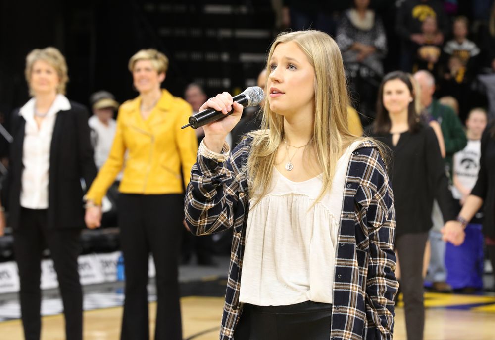 Iowa Hawkeyes head coach Lisa Bluder watches as her daughter Emma sings the National Anthem before the Iowa Hawkeyes game against the Northwestern Wildcats Sunday, March 3, 2019 at Carver-Hawkeye Arena. (Brian Ray/hawkeyesports.com)