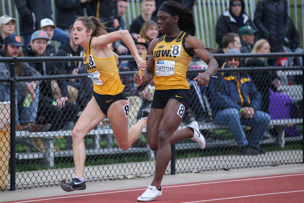 Iowa's Talia Buss and Antonise Christian during women's 4x100 meter relay at Big Ten Outdoor Track and Field Championships at Francis X. Cretzmeyer Track on Sunday, May 12, 2019. (Lily Smith/hawkeyesports.com)