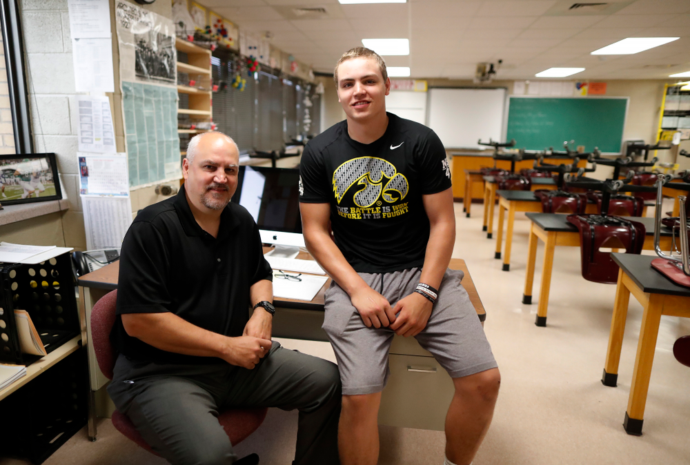 Iowa Hawkeyes quarterback Nathan Stanley (4) sits with his father Jay in his classroom at Menomonie High School Wednesday, May 30, 2018 in Menomonie, Wisc. (Brian Ray/hawkeyesports.com)