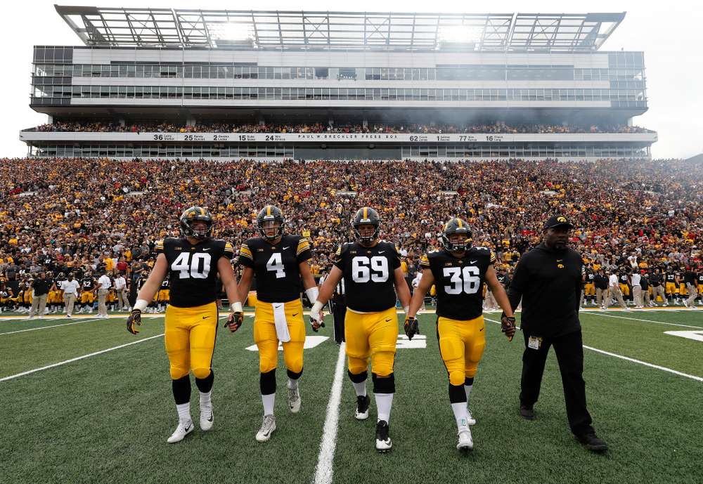 Iowa Hawkeyes captains defensive end Parker Hesse (40), quarterback Nate Stanley (4), offensive lineman Keegan Render (69), and fullback Brady Ross (36)against the Iowa State Cyclones Saturday, September 8, 2018 at Kinnick Stadium. (Brian Ray/hawkeyesports.com)
