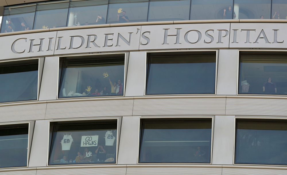 People look on from the University of Iowa Stead Family Children's Hospital as the Pat Green performs “Wave on Wave” during the second quarter of their Big Ten Conference football game at Kinnick Stadium in Iowa City on Saturday, Sep 7, 2019. (Stephen Mally/hawkeyesports.com)