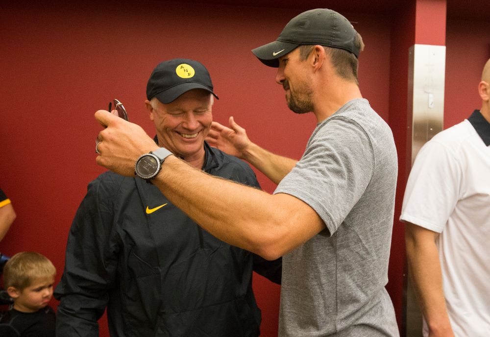 Former Iowa Hawkeyes tight end Dallas Clark talks with defensive line coach Reese Morgan as they celebrate their victory over the Iowa State Cyclones in the Iowa Corn Cy-Hawk Series Saturday, Sept. 12, 2015 at the Jack Trice Stadium in Ames. (Brian Ray/hawkeyesports.com)