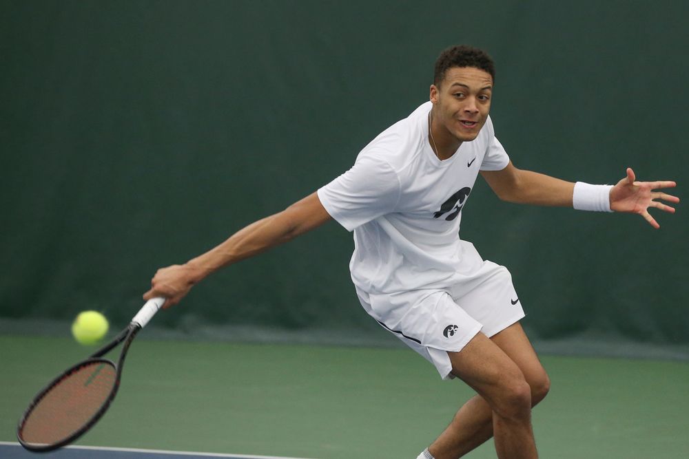 Iowa’s Oliver Okonkwo returns a hit during the Iowa men’s tennis meet vs Nebraska on Sunday, March 1, 2020 at the Hawkeye Tennis and Recreation Complex. (Lily Smith/hawkeyesports.com)