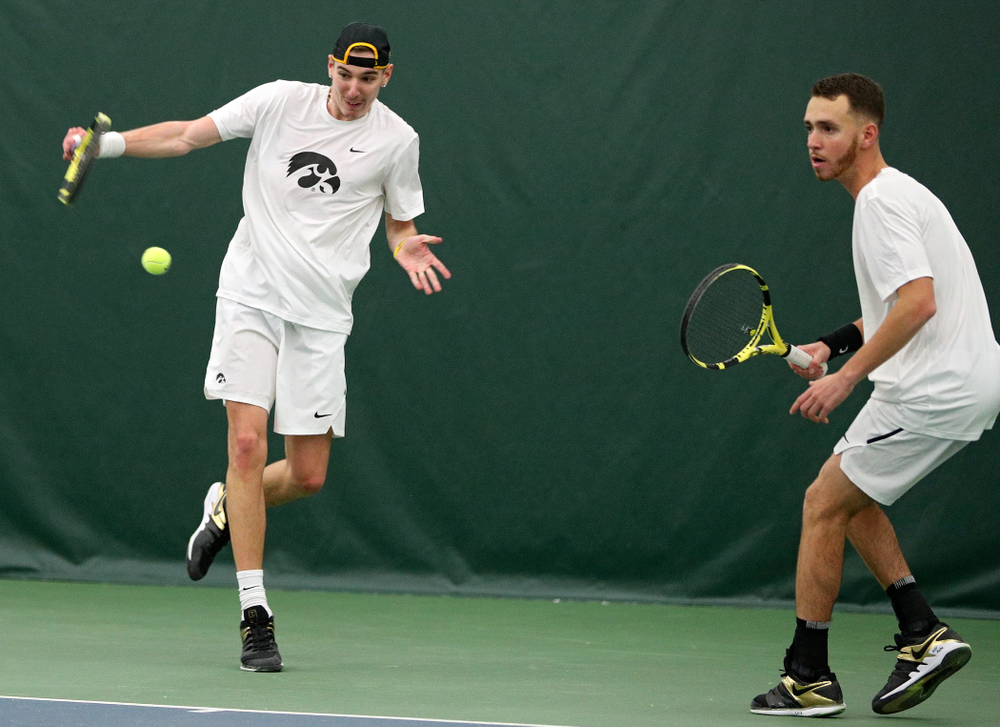 Iowa’s Nikita Snezhko (from left) returns a shot as Kareem Allaf looks on during their doubles match at the Hawkeye Tennis and Recreation Complex in Iowa City on Sunday, February 16, 2020. (Stephen Mally/hawkeyesports.com)