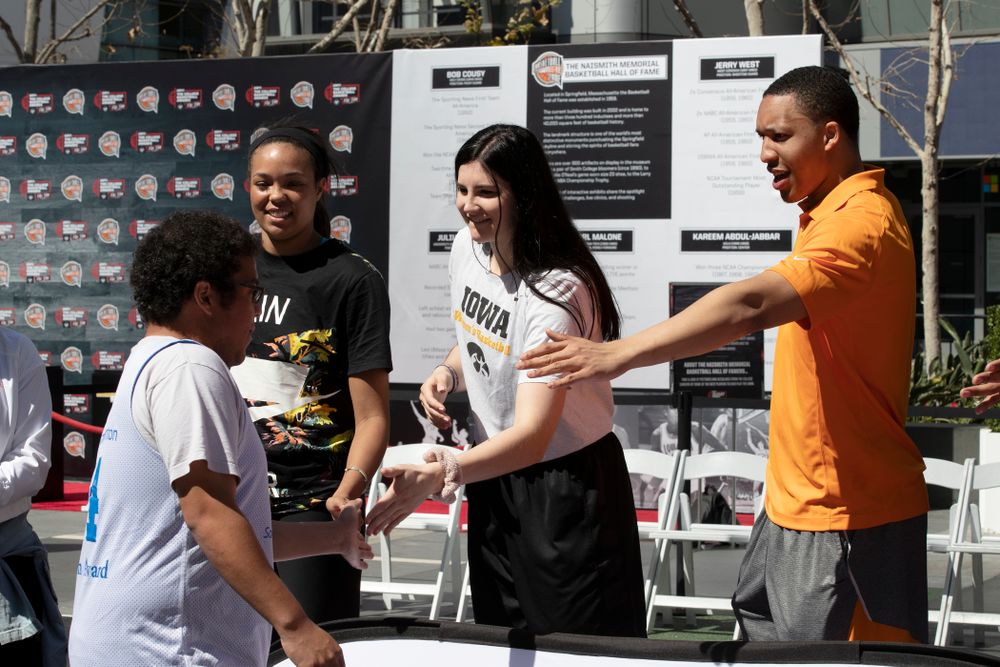 Iowa Hawkeyes forward Megan Gustafson (10) and TennesseeÕs Grant Williams slap hands with the athletes following a Special Olympics Event Friday, April 12, 2019 in the XBOX Plaza at LA Live. (Brian Ray/hawkeyesports.com)