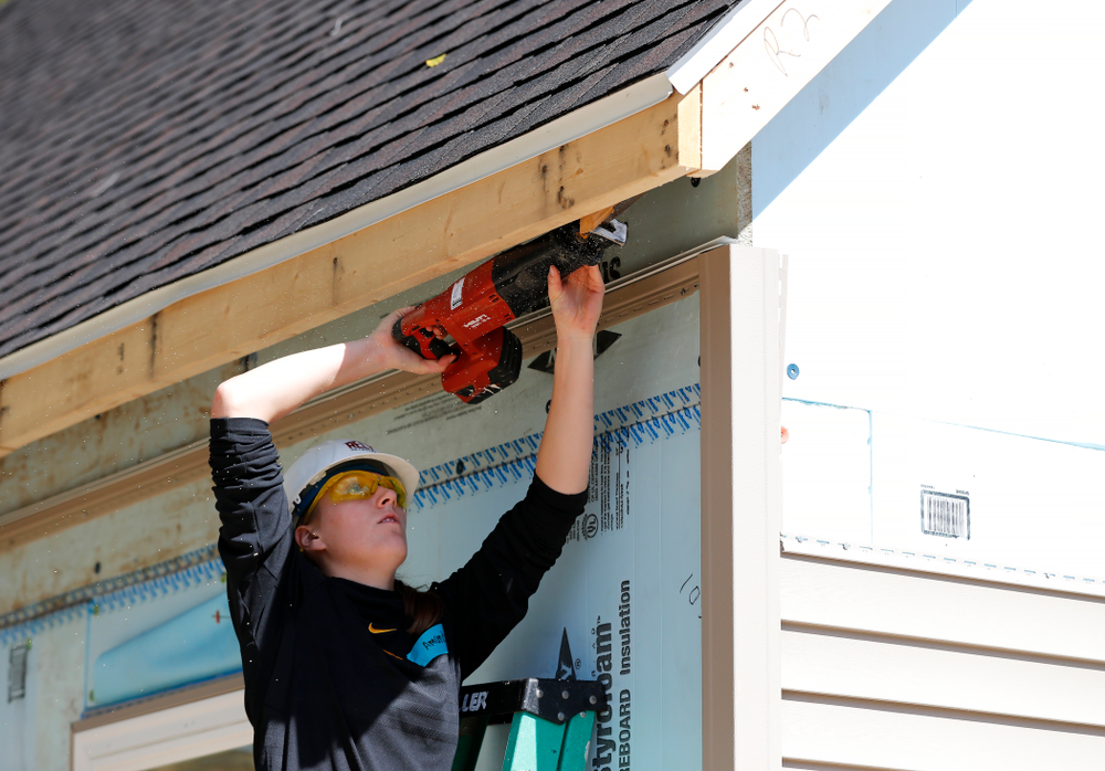 Iowa Hawkeyes forward Amanda Ollinger (43) works on the Habitat for Humanity Women's Build Wednesday, September 26, 2018 in Iowa City. (Brian Ray/hawkeyesports.com)