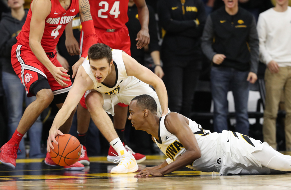 Iowa Hawkeyes forward Nicholas Baer (51) and guard Maishe Dailey (1) battle for a loose ball against the Ohio State Buckeyes Saturday, January 12, 2019 at Carver-Hawkeye Arena. (Brian Ray/hawkeyesports.com)